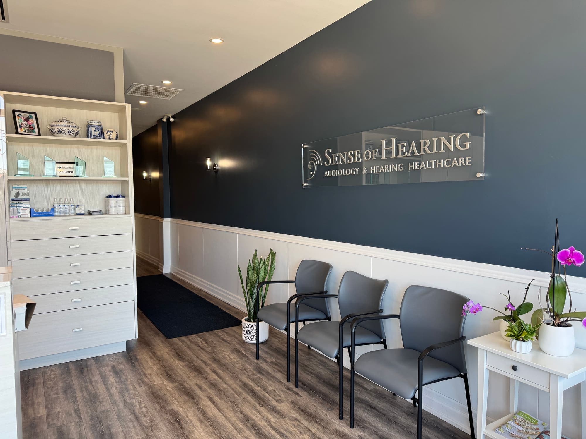 Reception area with product display and seating at Sense of Hearing Burlington