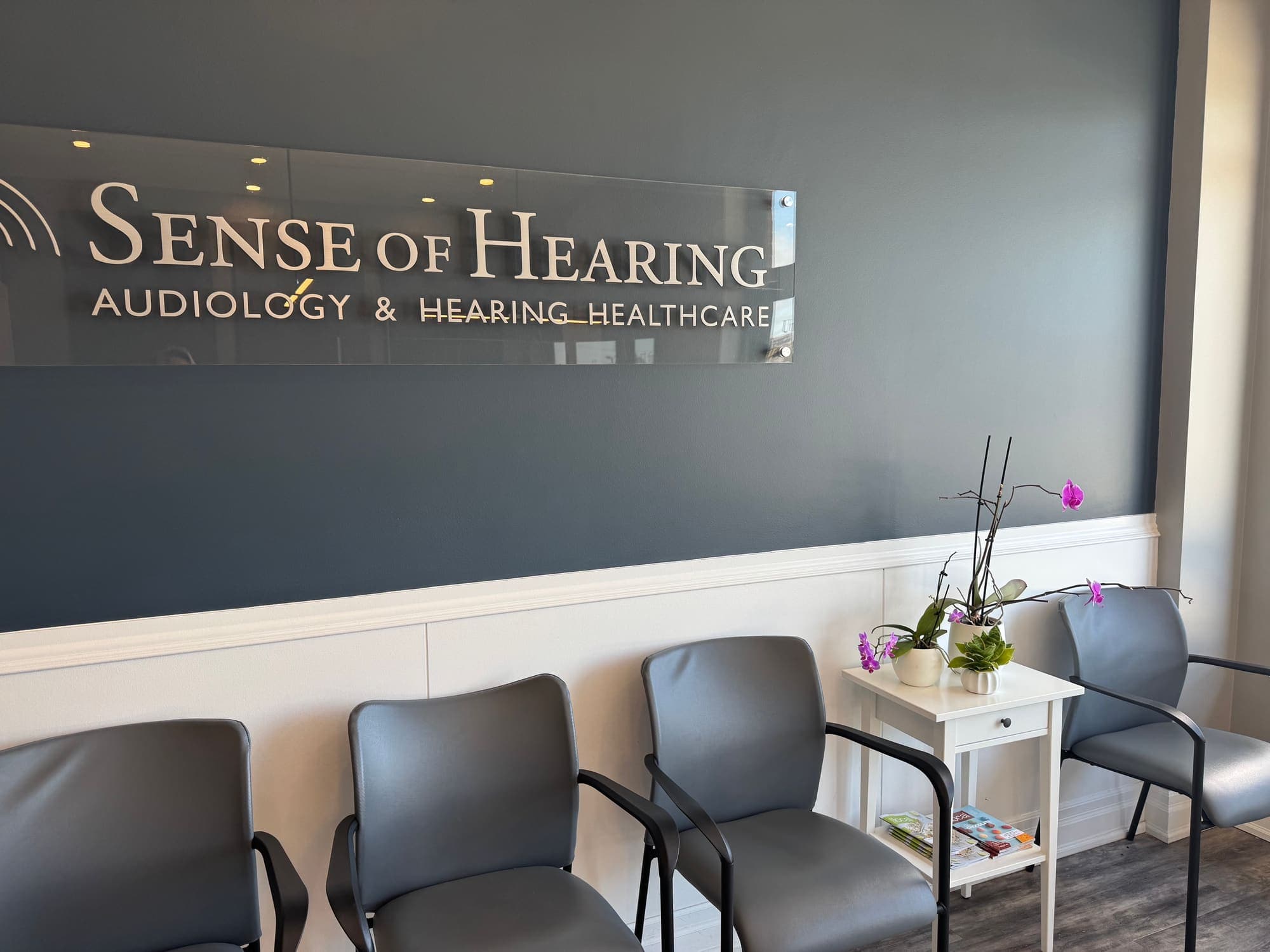 Waiting area beneath the Sense of Hearing sign at the Burlington clinic