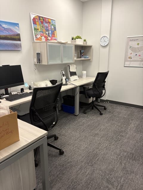 Consultation room at Sense of Hearing Oakville with audiogram poster and hearing assessment equipment