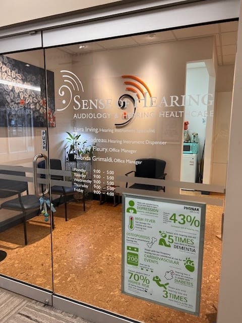 Glass entrance door at Sense of Hearing Welland listing the team and clinic hours