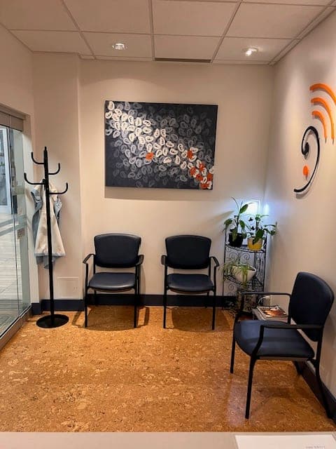 Waiting area at Sense of Hearing Welland with seating and wall artwork