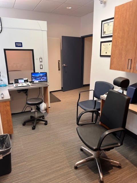 Consultation and fitting room with sound booth and framed credentials at Sense of Hearing Welland
